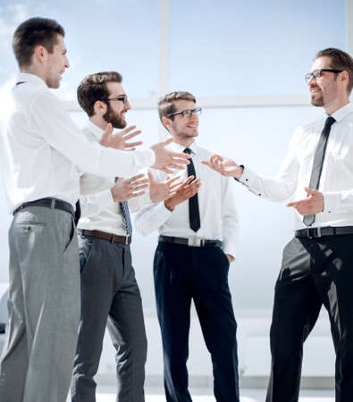 employees discussing their ideas standing in the office lobbyの写真素材