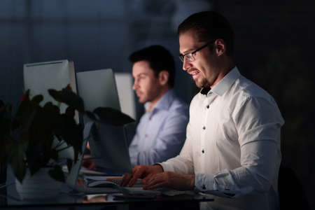 close up.employee of the company working after hours