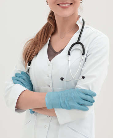portrait of smiling female doctor on light backgroundの写真素材