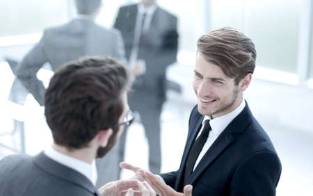 business colleagues talking standing in the lobby of the busines