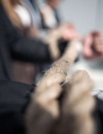 Hands of businessmen, twisted by a ropeの写真素材