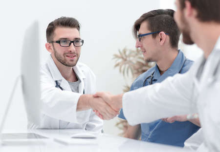 handshake between the two doctors during the working meeting