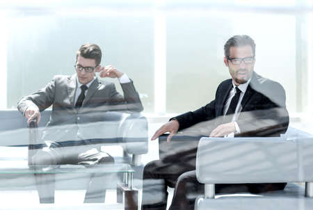 two business partners sitting in the office.の写真素材