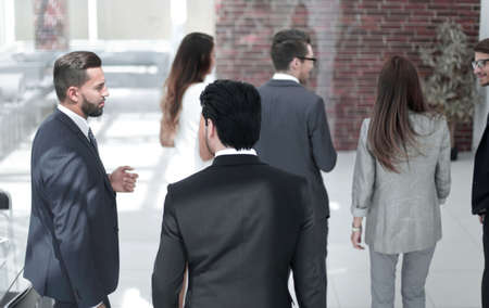 employees standing in the hall of a modern officeの写真素材