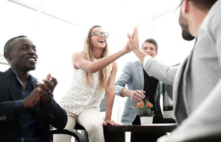 smiling employees giving each other a high five
