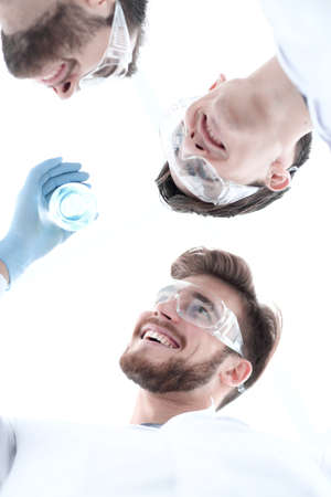 closeup.a group of scientists looks at the liquid in the beakerの写真素材