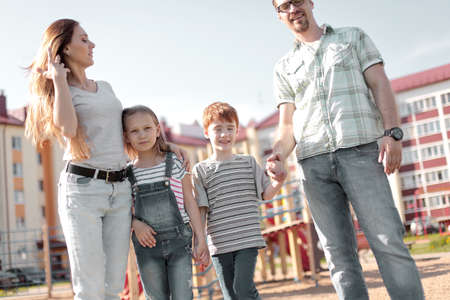 happy family standing in the courtyard of an apartment buildingの写真素材