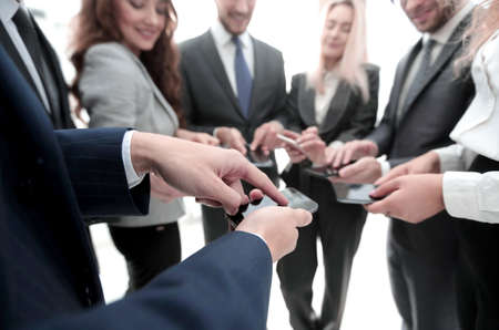 close-up of smartphones in the hands of business youthの写真素材