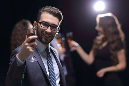 elegant man raising his glass with the toastの写真素材