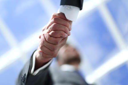 close up.handshake of business people on a light background.