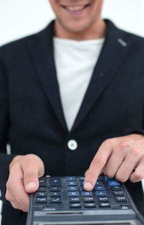 close up.smiling businessman counting profits on calculator.の写真素材