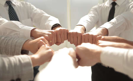 close up.smiling business team standing in a circleの写真素材