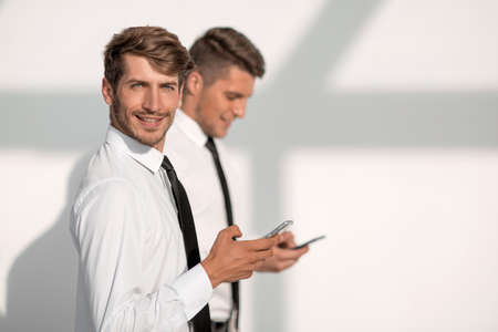 Businessmans holding mobile phone
