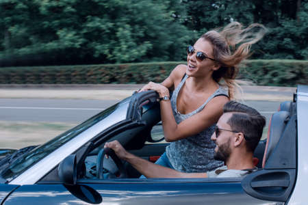 Couple of lovers driving on a convertible carの写真素材