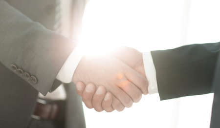 Businessman giving his hand for handshake to partner