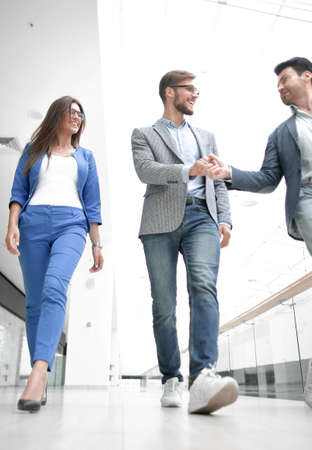 employees greet each other in the office buildingの写真素材