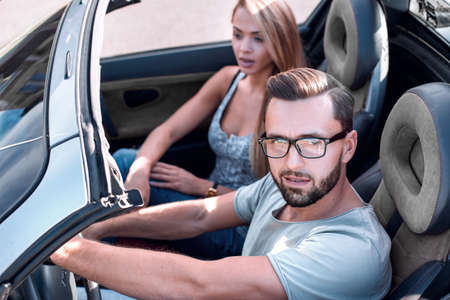 close up.successful man traveling in a convertible carの写真素材