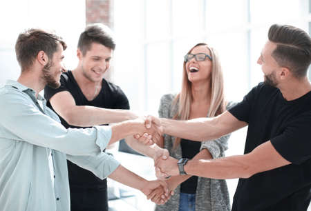 Happy smiling business team standing in a row at office.