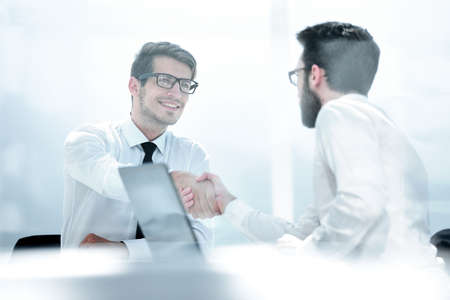 two employees greet each other at the Deskの写真素材