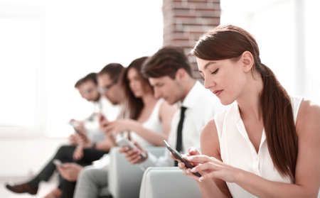 young employee looking at text message on smartphone