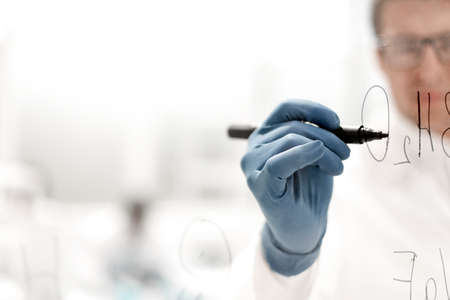 background image.scientist making notes on a transparent Boardの写真素材