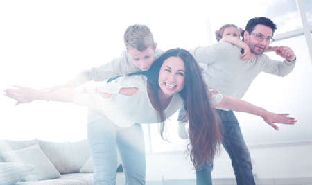loving parents playing with children at their home