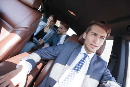 group of business people in a luxury car