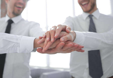 group of company employees folded the tower from their hands