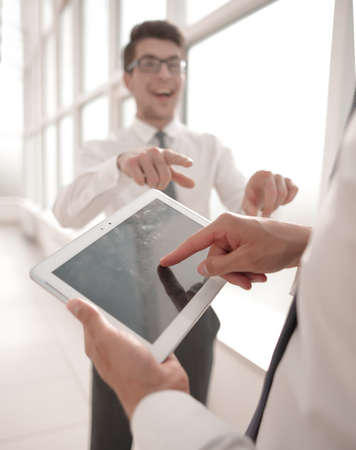 close up.employees discuss standing in the hallway of the officeの写真素材