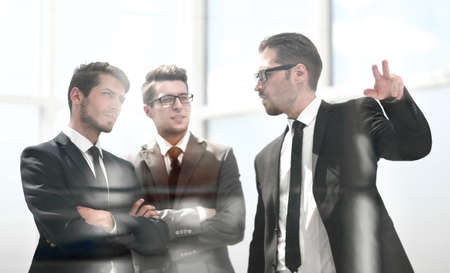 business partners standing near the office windowの写真素材