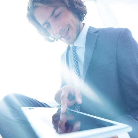 portrait of successful businessman working on tablet computer.の写真素材