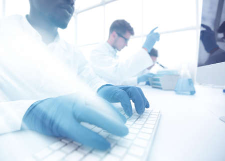 close up.scientist typing on computer keyboard.の写真素材