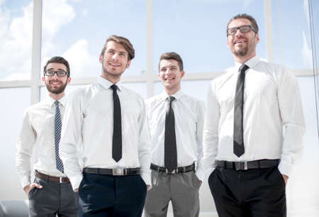 group of successful business people standing near the window.
