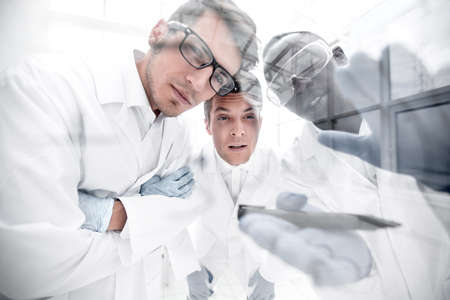close up.a group of scientists discussing the results of the experimen