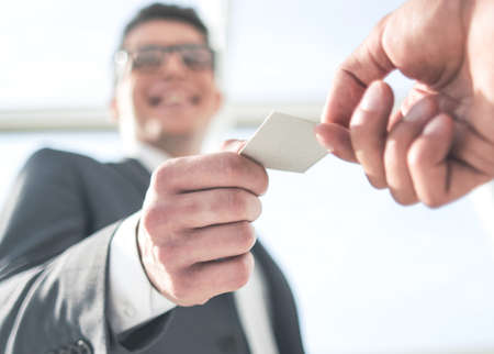 bottom view.businessmen partners exchanging their business cards