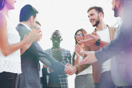 handshake of business partners and applauding business team