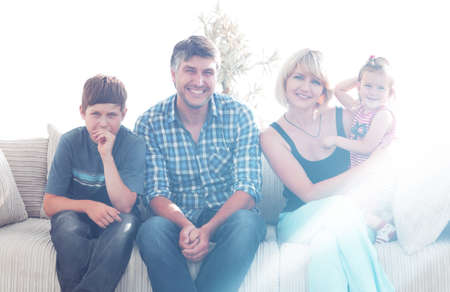 Young couple with their cute kids having rest at home