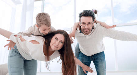loving parents playing with children at their homeの写真素材