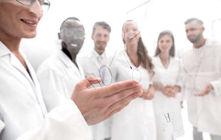 gay biologists are discussing a formula that is written on the boardの写真素材