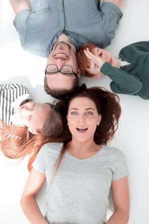 top view. happy parents with children to relax by lying on the floorの写真素材