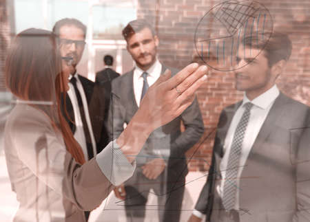 business woman showing information on a glass Boardの写真素材