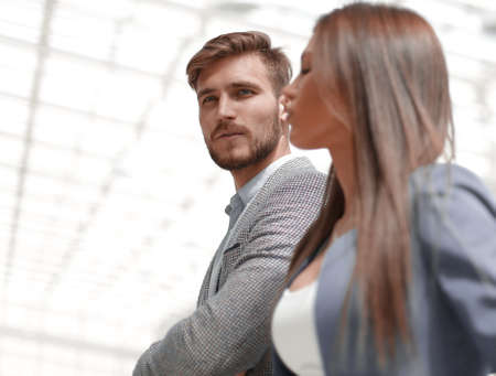 business couple standing in a bright officeの写真素材