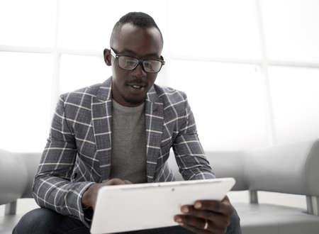 young businessman looking at digital tablet screen.