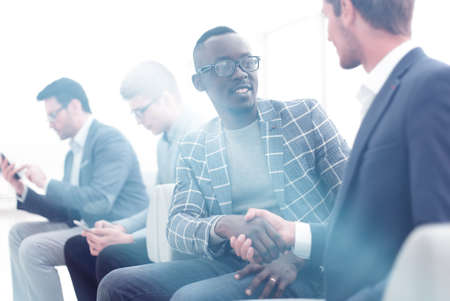 handshake business people sitting in the officeの写真素材