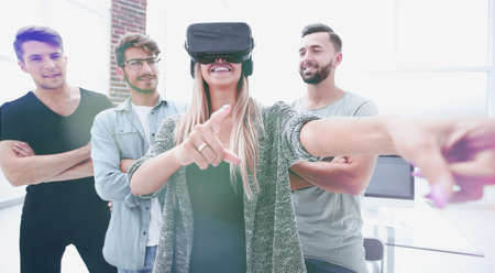 woman standing in the office with VR glasses