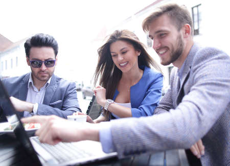 business team using a laptop in a street cafeの写真素材