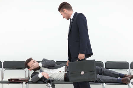 businessman talking to a tired visitorの写真素材