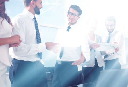 group of employees discussing financial documentsの写真素材