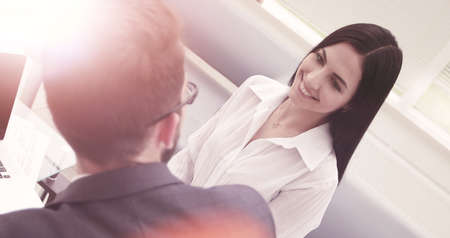 close-up of a young business woman talking with a colleague.