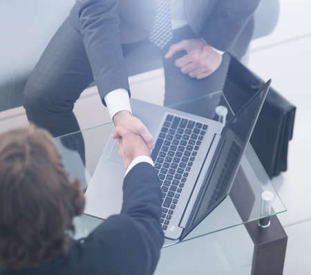 handshake of business partners above the Desk.の写真素材